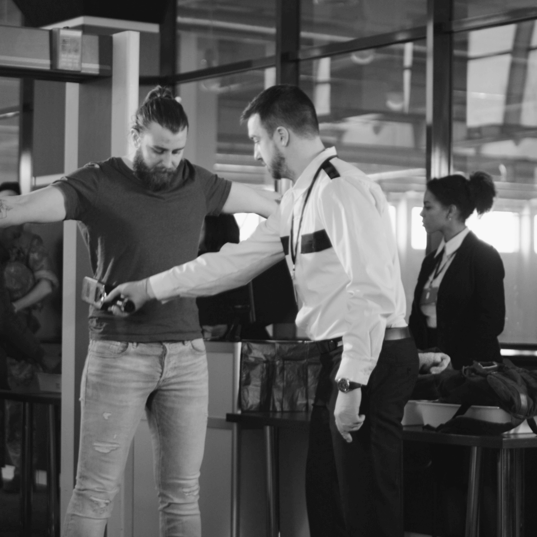 Security guard testing a civilian for potential contamination at a check point